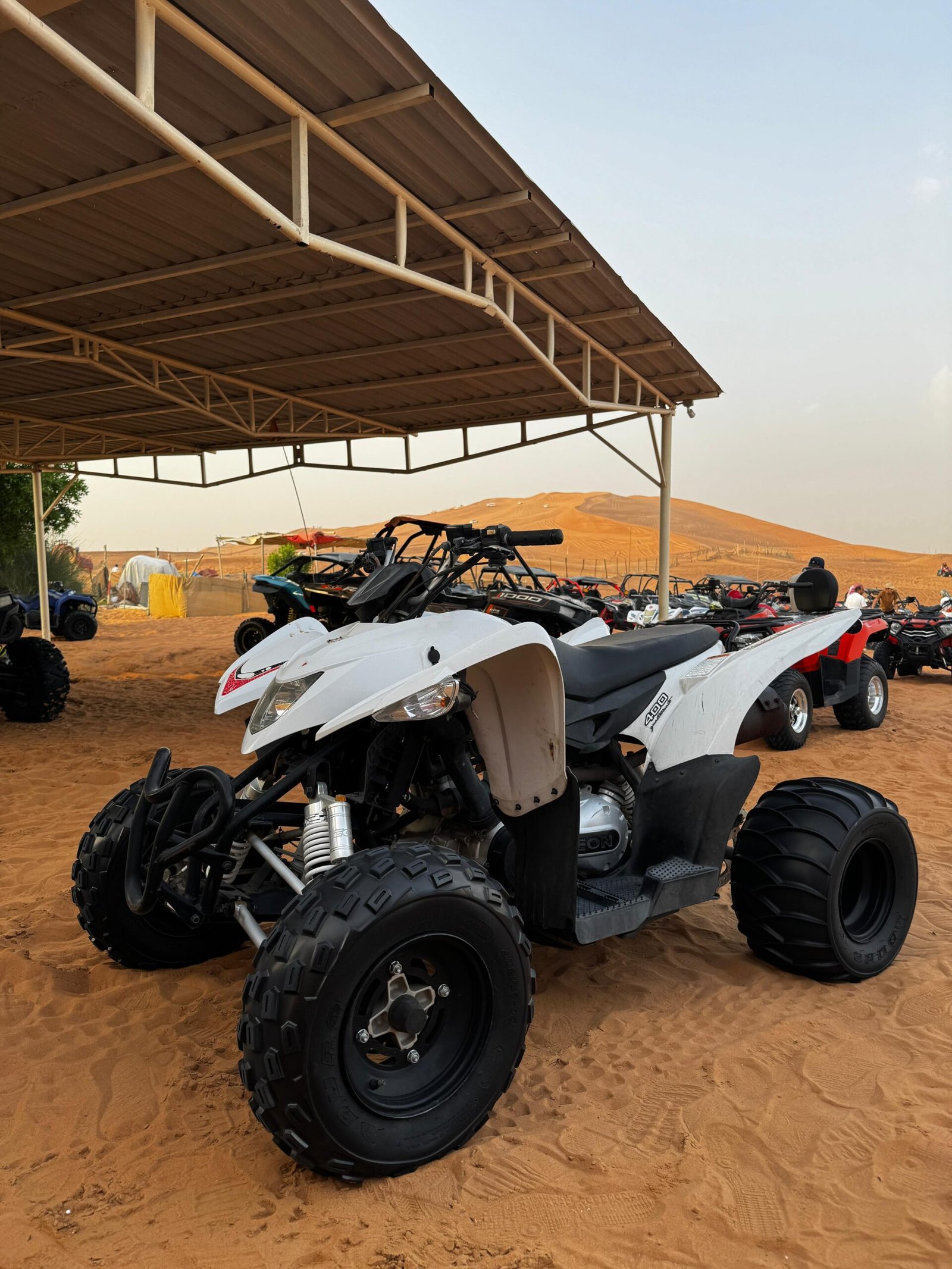 400cc quad bike parked on the golden sand dunes in Dubai