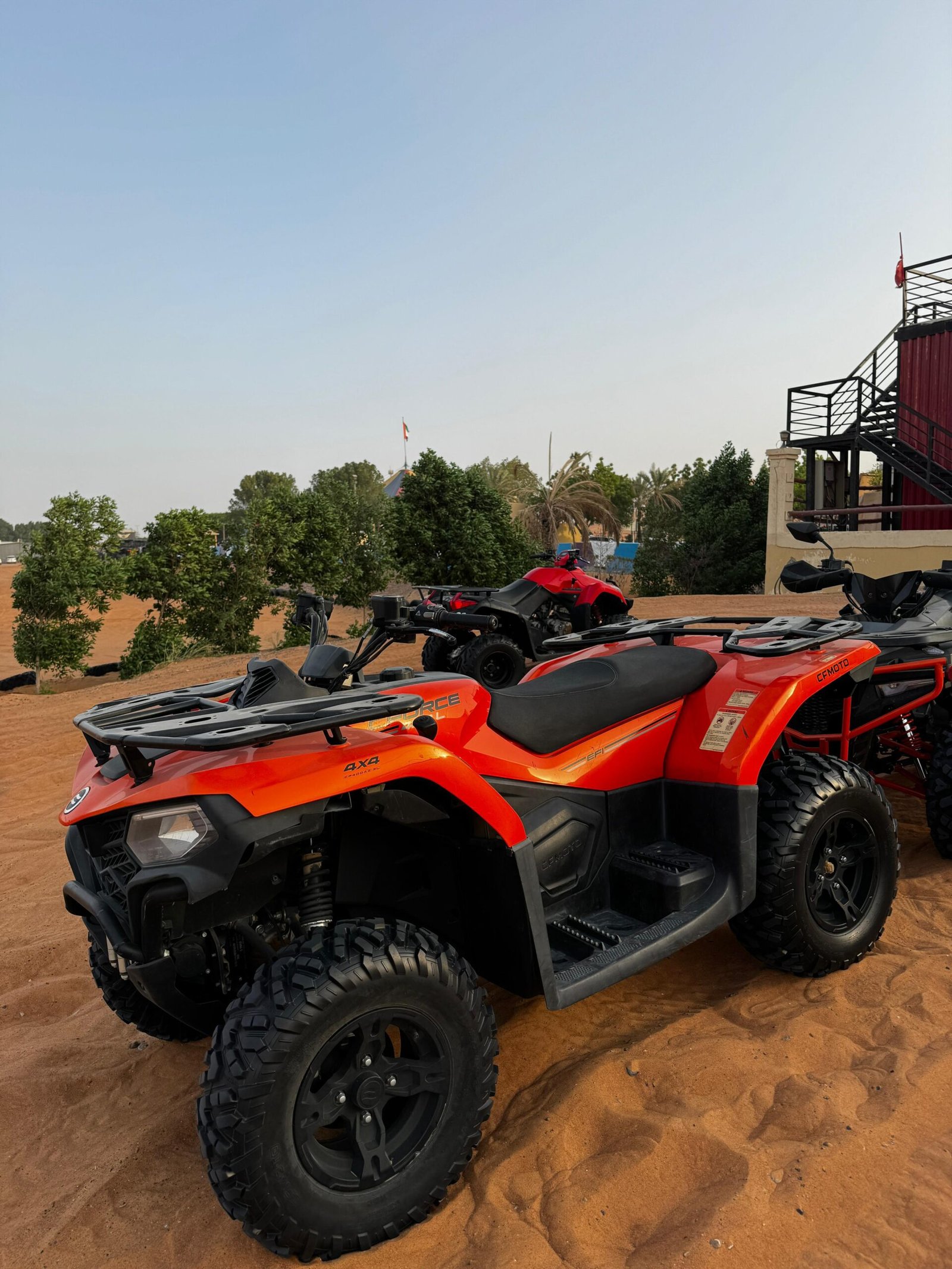 300cc quad bike parked on golden dunes in Dubai