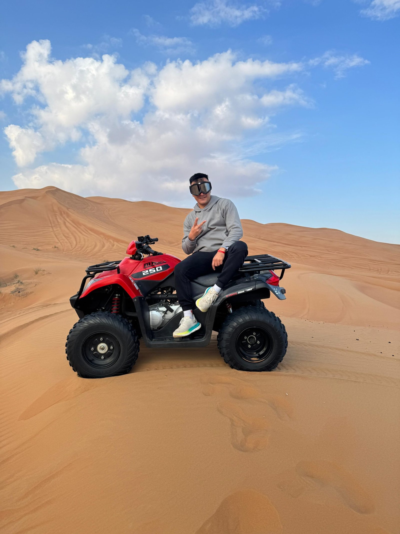 KYMCO 250cc quad bike with rider on desert dunes