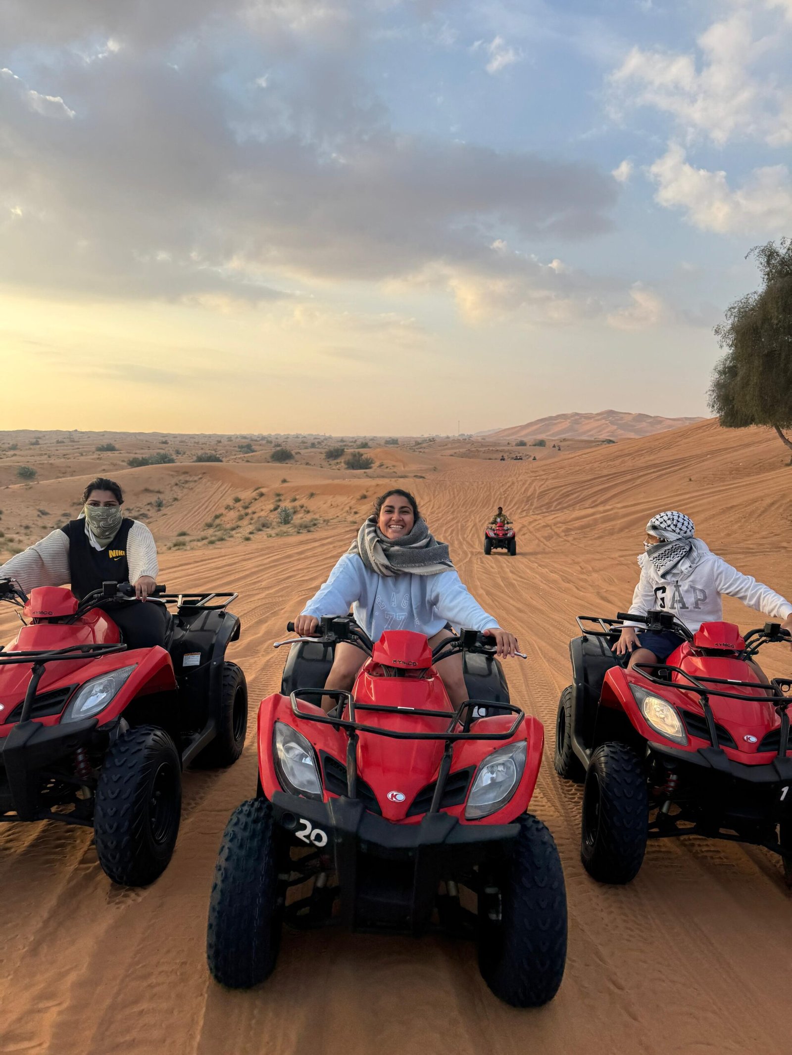 KYMCO 250cc quad parked with wide desert backdrop
