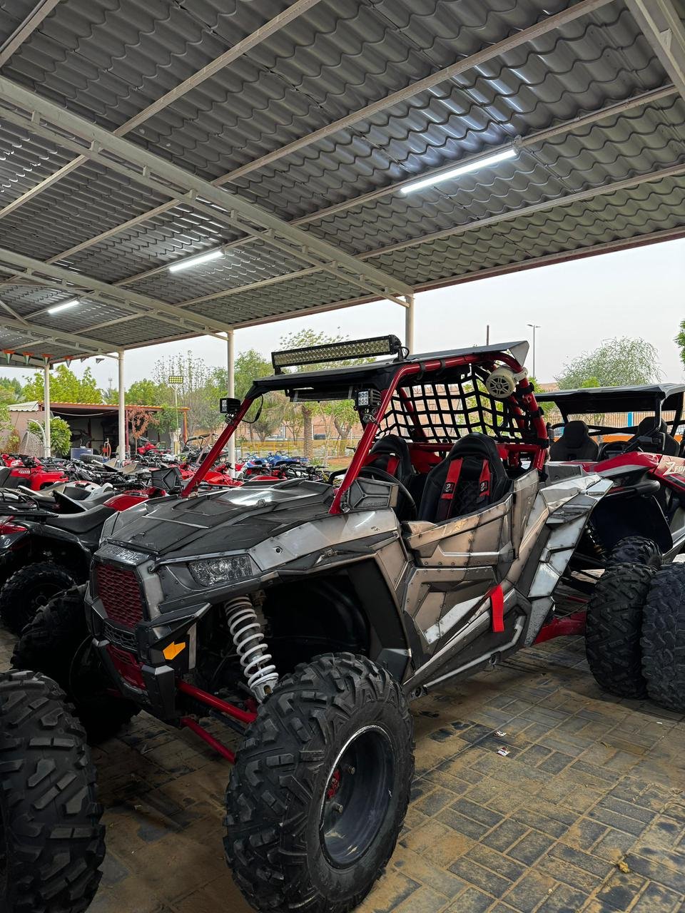 Polaris 2-seater buggy pausing on the crest of a dune